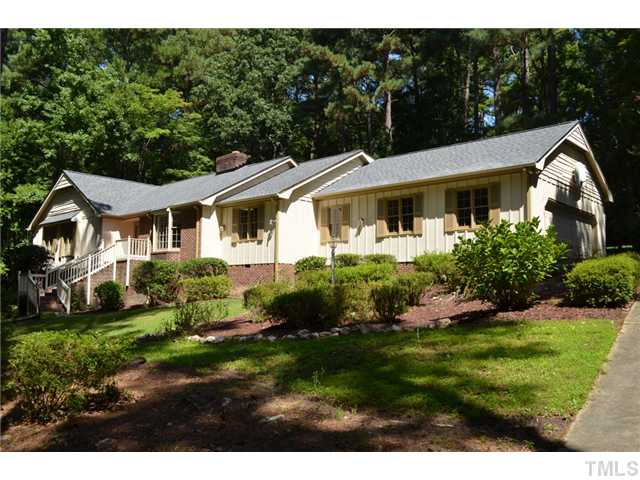 5004 Springwood Drive Raleigh, NC 27613 - Photo 1 of 22 a front view of a house with a garden