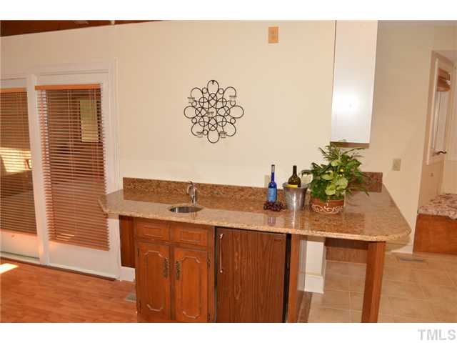 5004 Springwood Drive Raleigh, NC 27613 - Photo 11 of 22 a kitchen with a sink a counter and a dining table