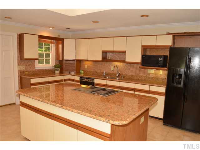 5004 Springwood Drive Raleigh, NC 27613 - Photo 12 of 22 a kitchen with a sink and a refrigerator