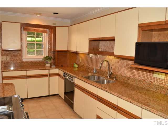 5004 Springwood Drive Raleigh, NC 27613 - Photo 13 of 22 a kitchen with stainless steel appliances granite countertop a sink and a stove