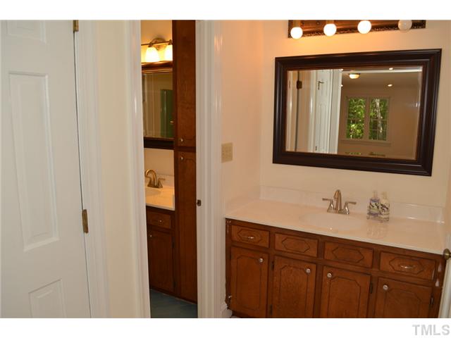 5004 Springwood Drive Raleigh, NC 27613 - Photo 18 of 22 a bathroom with a sink and a mirror