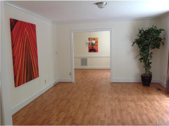 5004 Springwood Drive Raleigh, NC 27613 - Photo 4 of 22 an empty room with potted plants