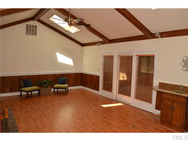 5004 Springwood Drive Raleigh, NC 27613 - Photo 10 of 22 a view of an empty room with furniture and chandelier