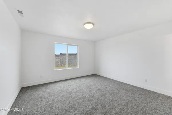 a view of an empty room with closet