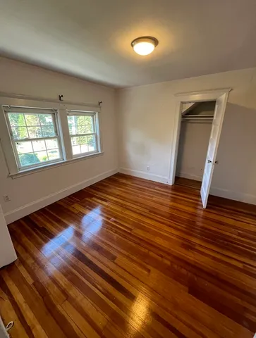 a view of room with stairs and wooden floor