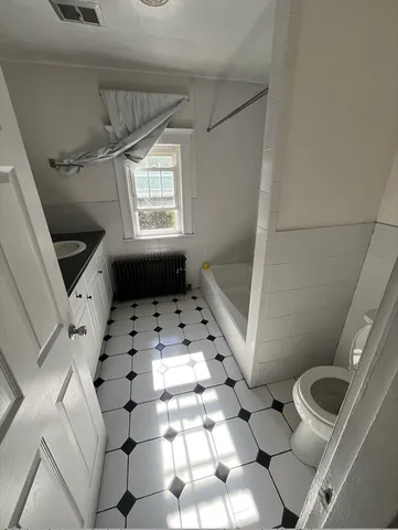a kitchen with granite countertop a sink a stove and cabinets