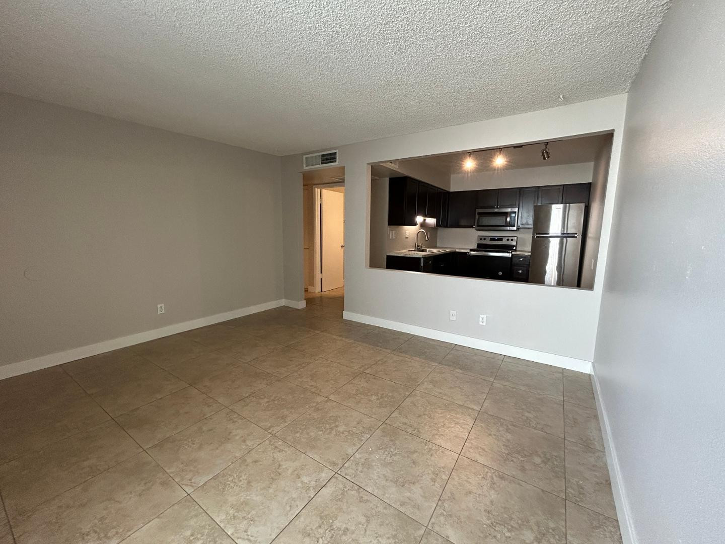 859 South Ext Road Mesa, AZ 85210 - Photo 5 of 19 a view of a livingroom and an empty room with a fireplace