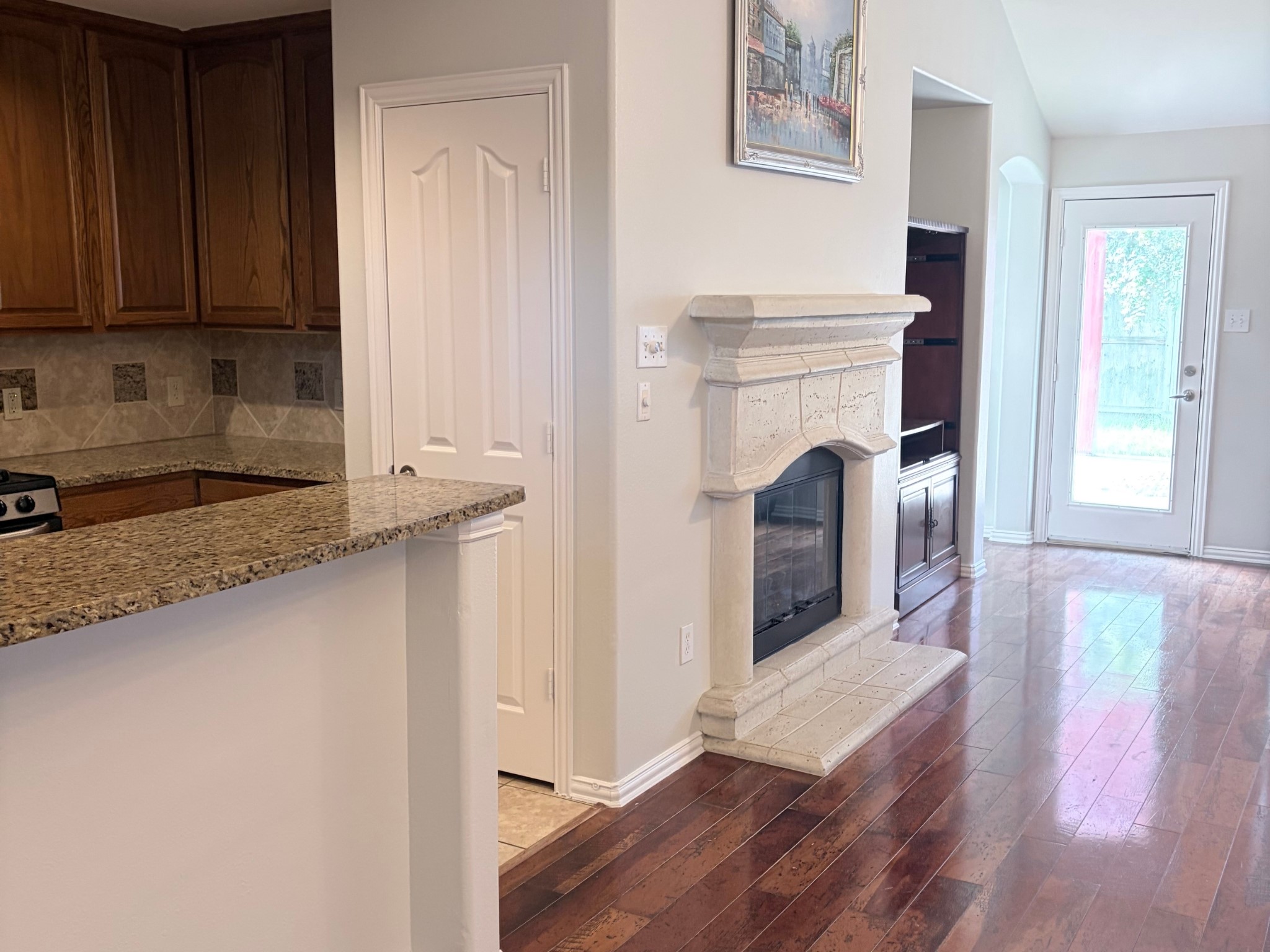 Close-up view of the cozy fireplace and direct access to the back area