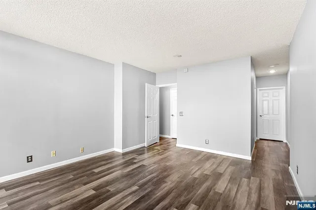 a view of room with wooden floor