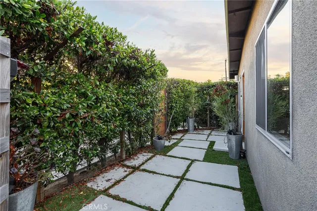 a view of a pathway both side of house