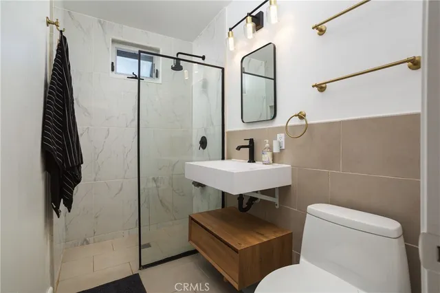 a bathroom with a sink toilet and shower