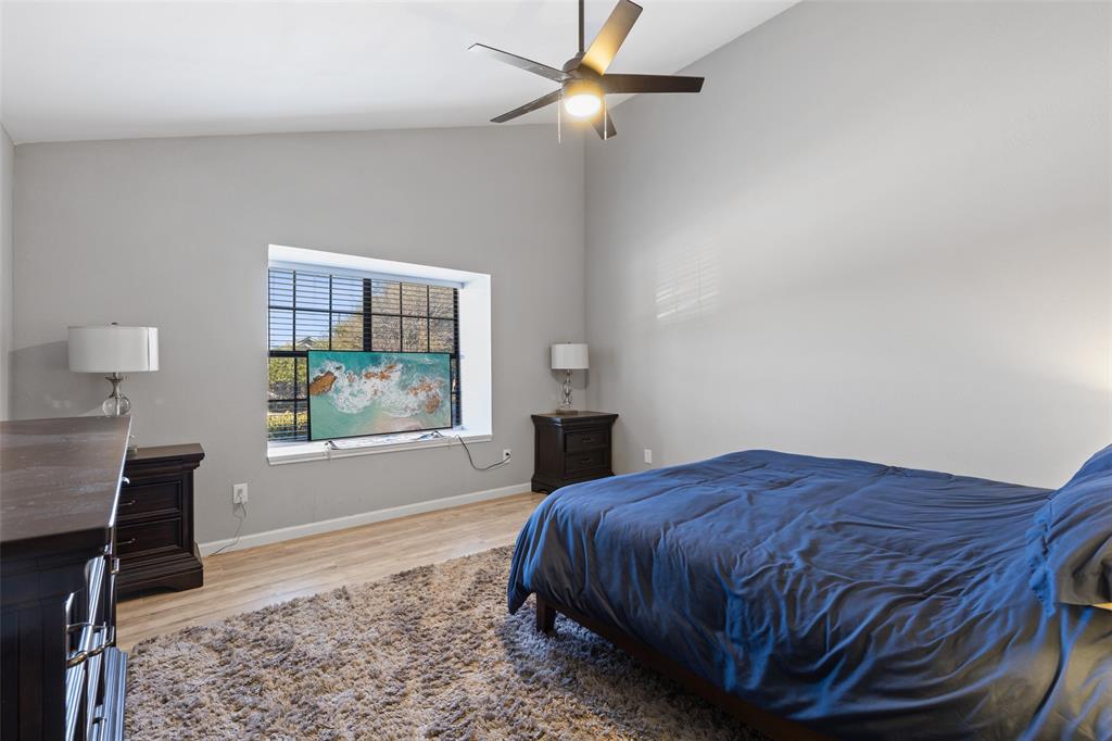 19016 Tupelo Lane Dallas, TX 75007 - Photo 12 of 28 a bedroom with a bed and a window