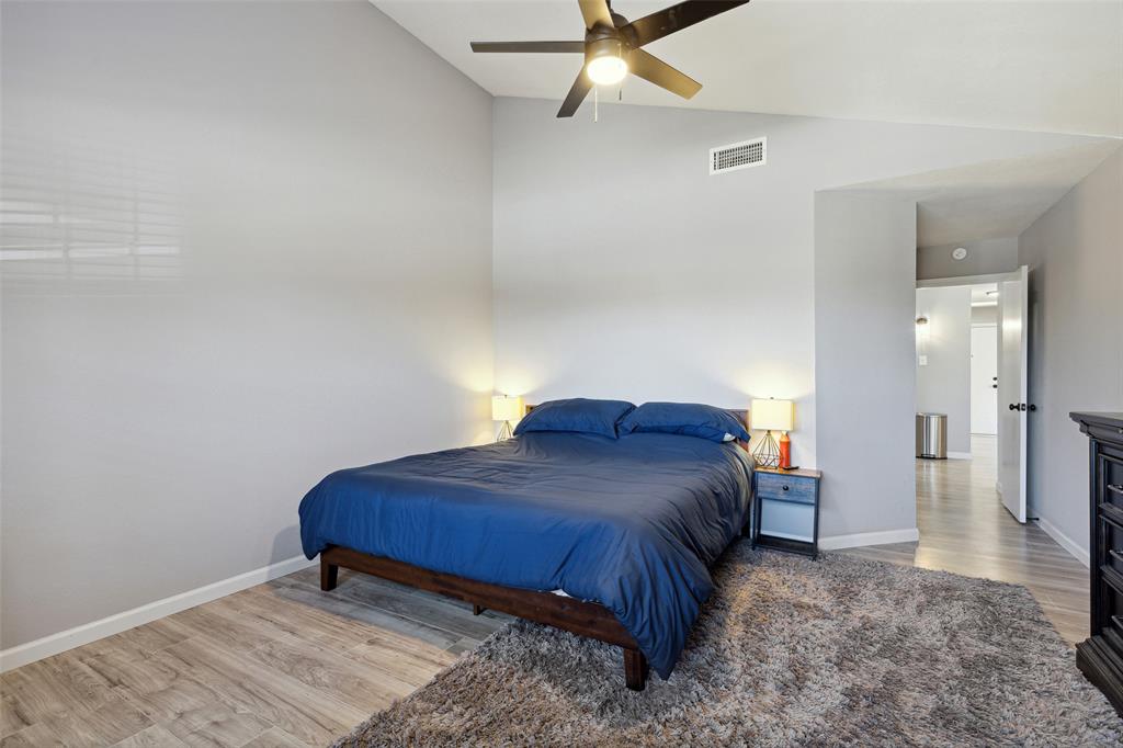 19016 Tupelo Lane Dallas, TX 75007 - Photo 13 of 28 a bedroom with a bed and a view of bathroom