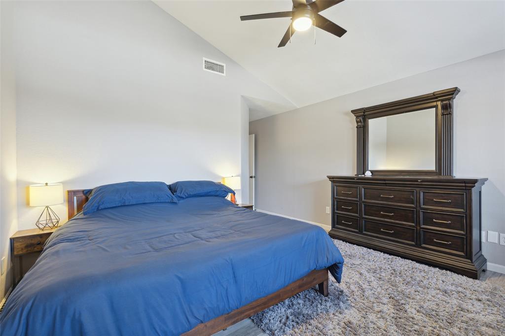 19016 Tupelo Lane Dallas, TX 75007 - Photo 14 of 28 a bedroom with a bed and a dresser