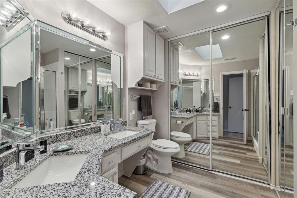 19016 Tupelo Lane Dallas, TX 75007 - Photo 15 of 28 a large bathroom with a double vanity sink a mirror and a shower
