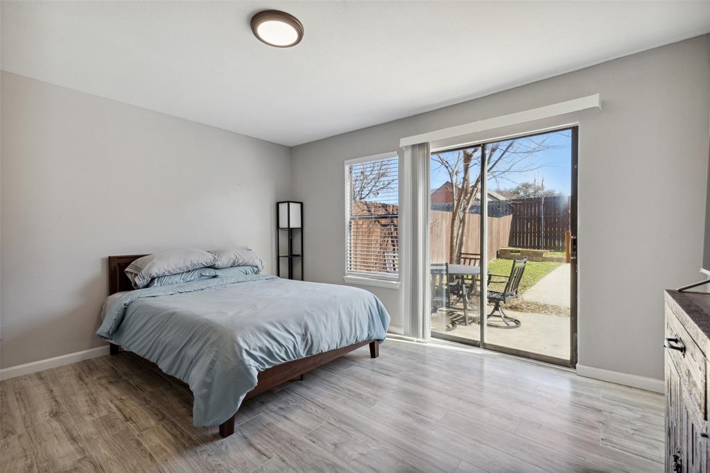 19016 Tupelo Lane Dallas, TX 75007 - Photo 18 of 28 a bedroom with a large bed and a window