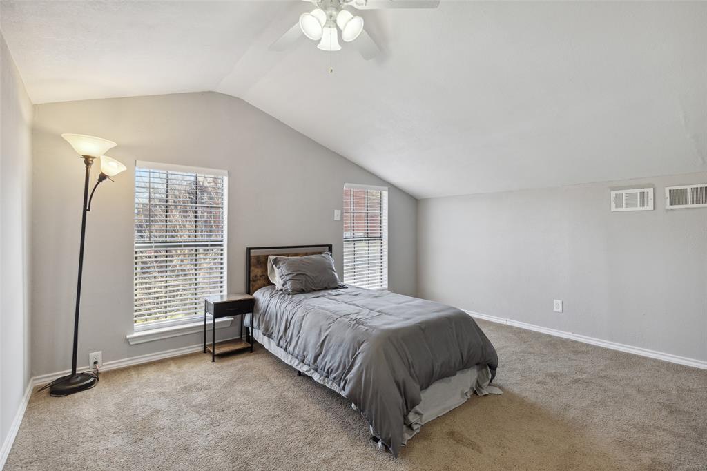 19016 Tupelo Lane Dallas, TX 75007 - Photo 20 of 28 a bedroom with a bed and a window