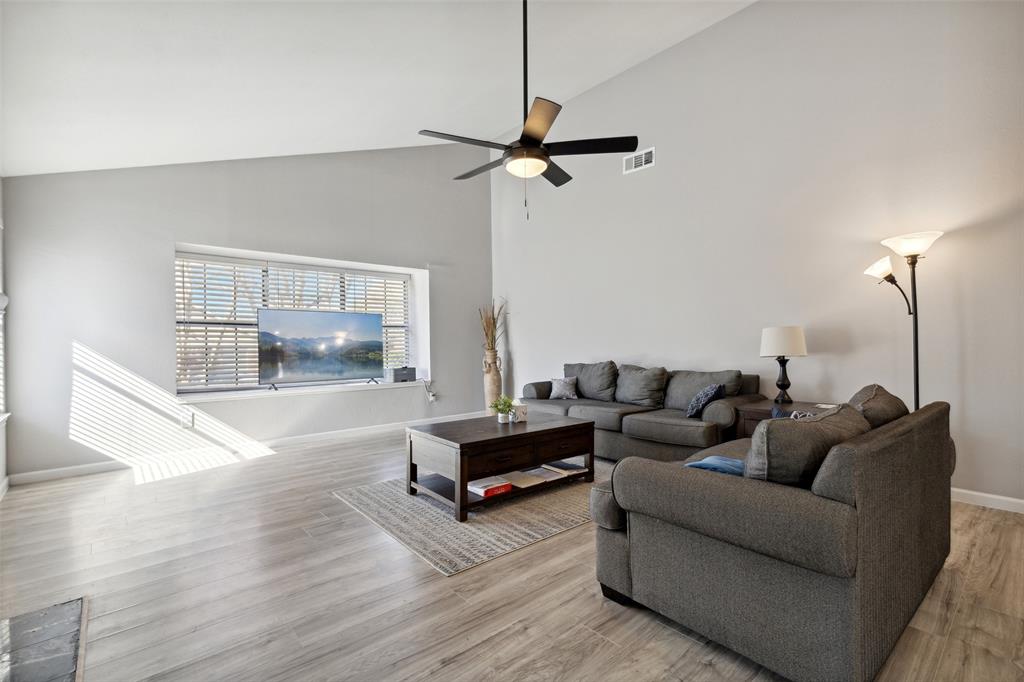 19016 Tupelo Lane Dallas, TX 75007 - Photo 2 of 28 a living room with furniture and a table