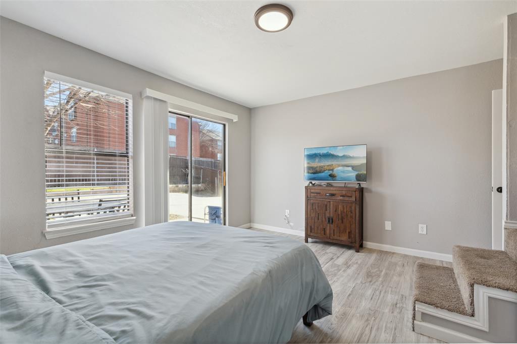 19016 Tupelo Lane Dallas, TX 75007 - Photo 23 of 28 a bedroom with a bed and a large window