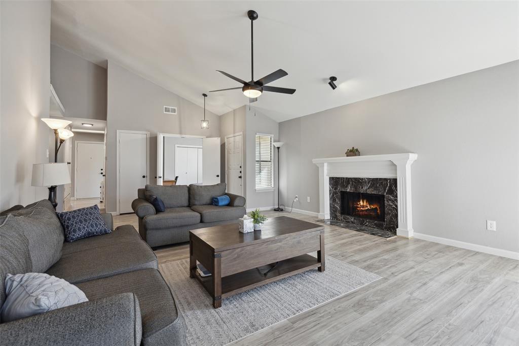 19016 Tupelo Lane Dallas, TX 75007 - Photo 4 of 28 a living room with furniture and a fireplace