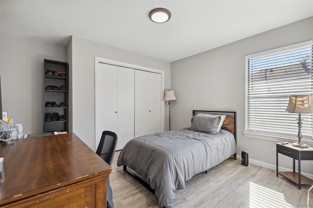 19016 Tupelo Lane Dallas, TX 75007 - Photo 10 of 28 a bedroom with a bed and a desk