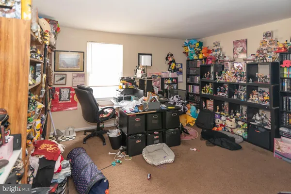 a room with furniture a rug toys and a chandelier