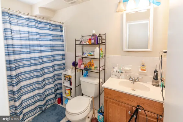 a bathroom with a sink mirror vanity and toilet