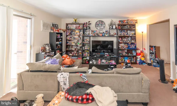 a living room with lots of furniture and a fireplace