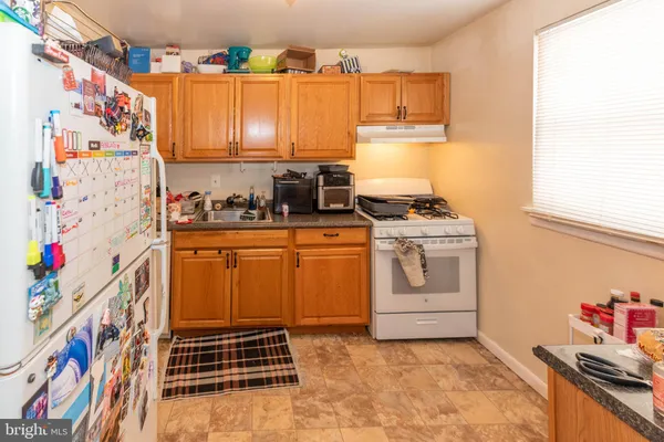 a kitchen with stainless steel appliances a stove a sink and a refrigerator