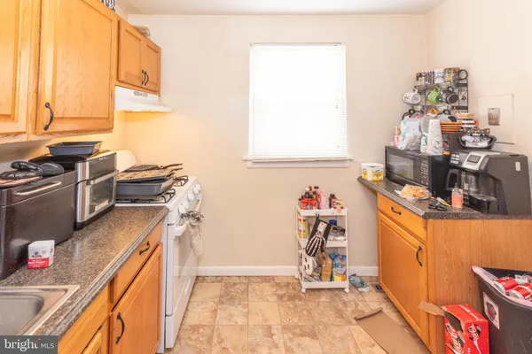 a view of a kitchen with fridge and workspace