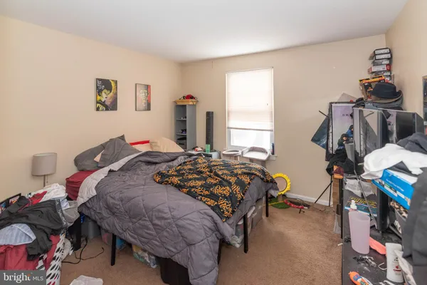 a bedroom with bed and a window