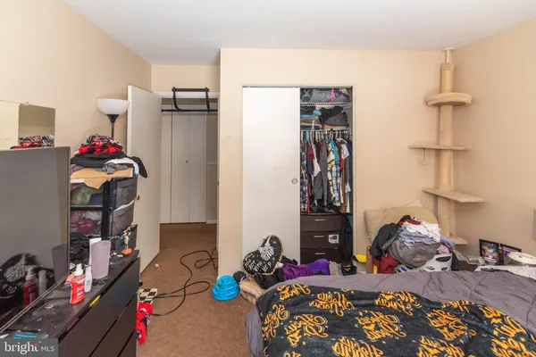a bedroom with furniture and a closet