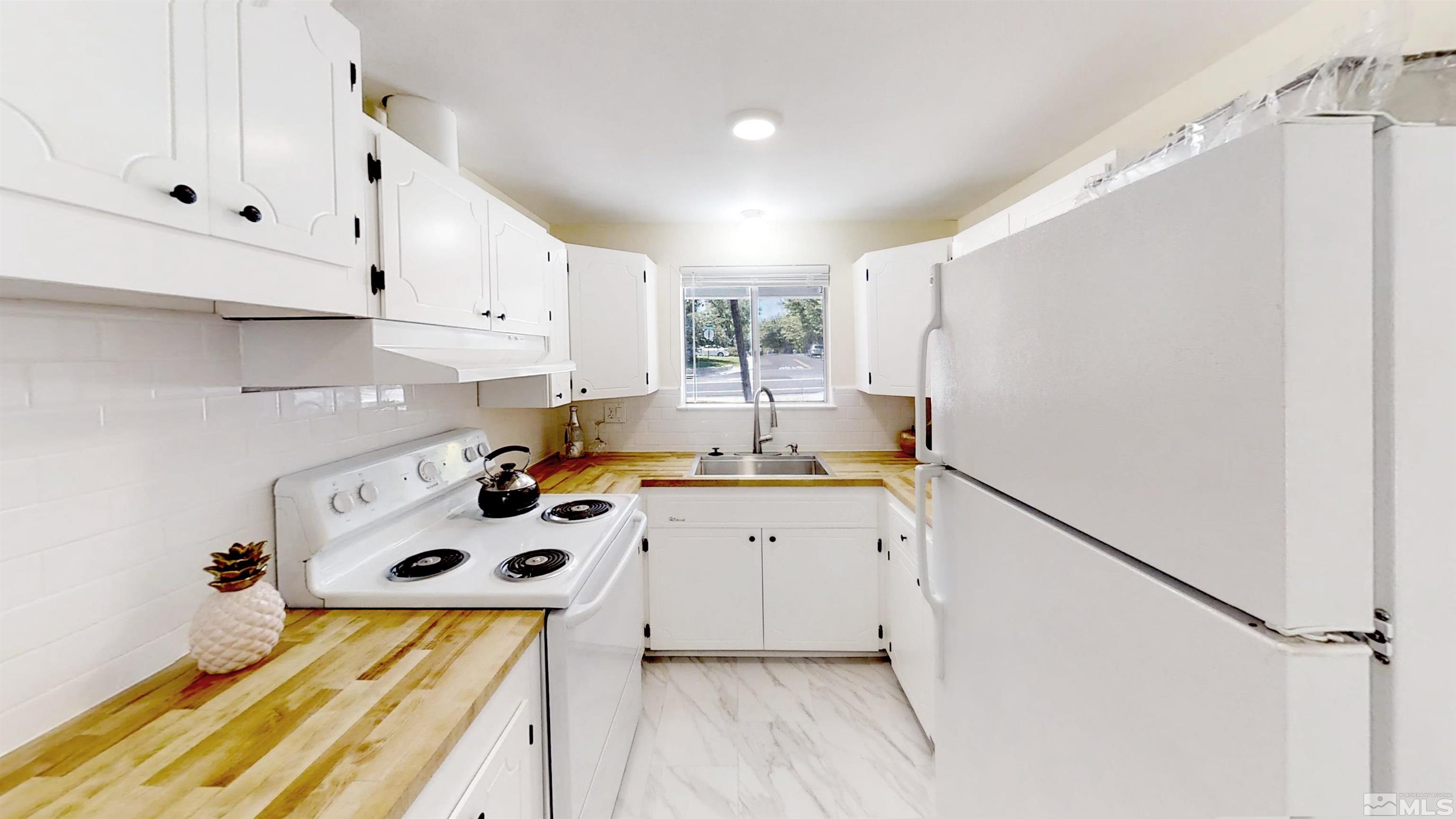 1690 Keystone Avenue Reno, NV 89503 - Photo 12 of 18 a kitchen with a sink a stove and refrigerator