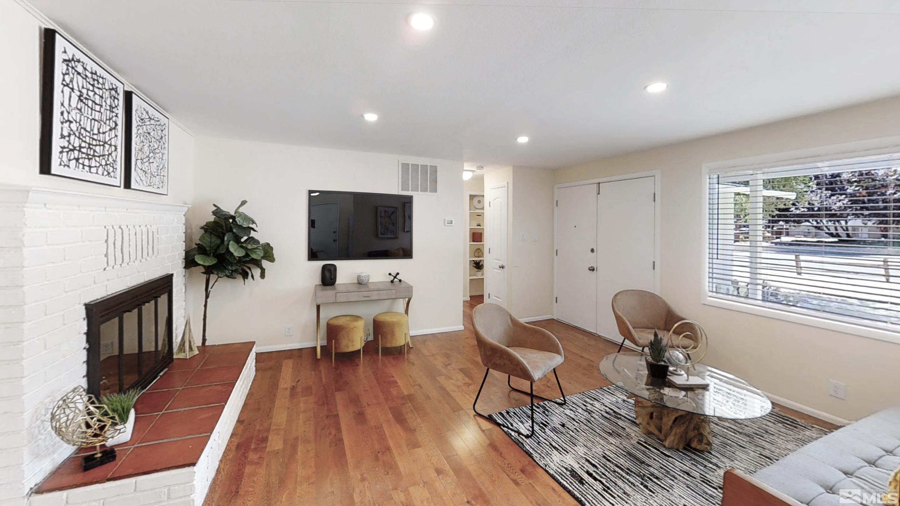 1690 Keystone Avenue Reno, NV 89503 - Photo 10 of 18 a living room with furniture a fireplace and a flat screen tv