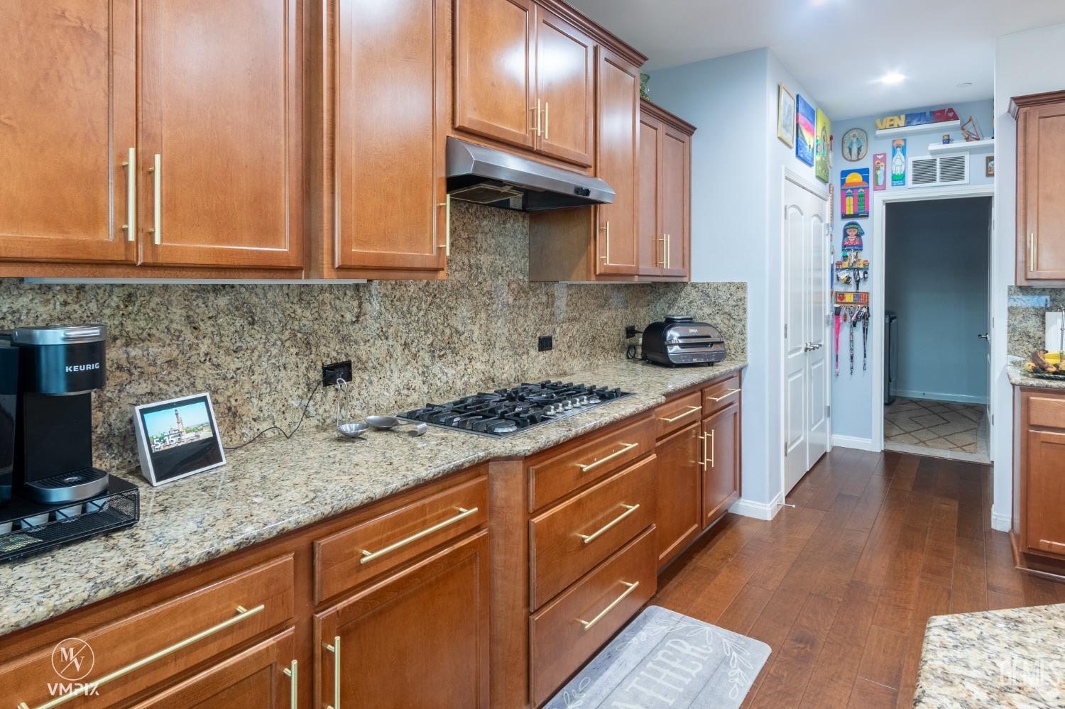 Undisclosed Address Bakersfield, CA 93311 - Photo 18 of 55 a kitchen with stainless steel appliances granite countertop a stove a sink and a refrigerator