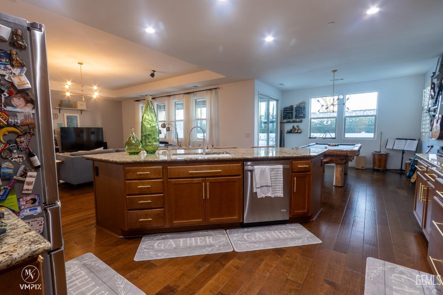 Undisclosed Address Bakersfield, CA 93311 - Photo 21 of 55 a kitchen with stainless steel appliances granite countertop a stove a sink and a refrigerator