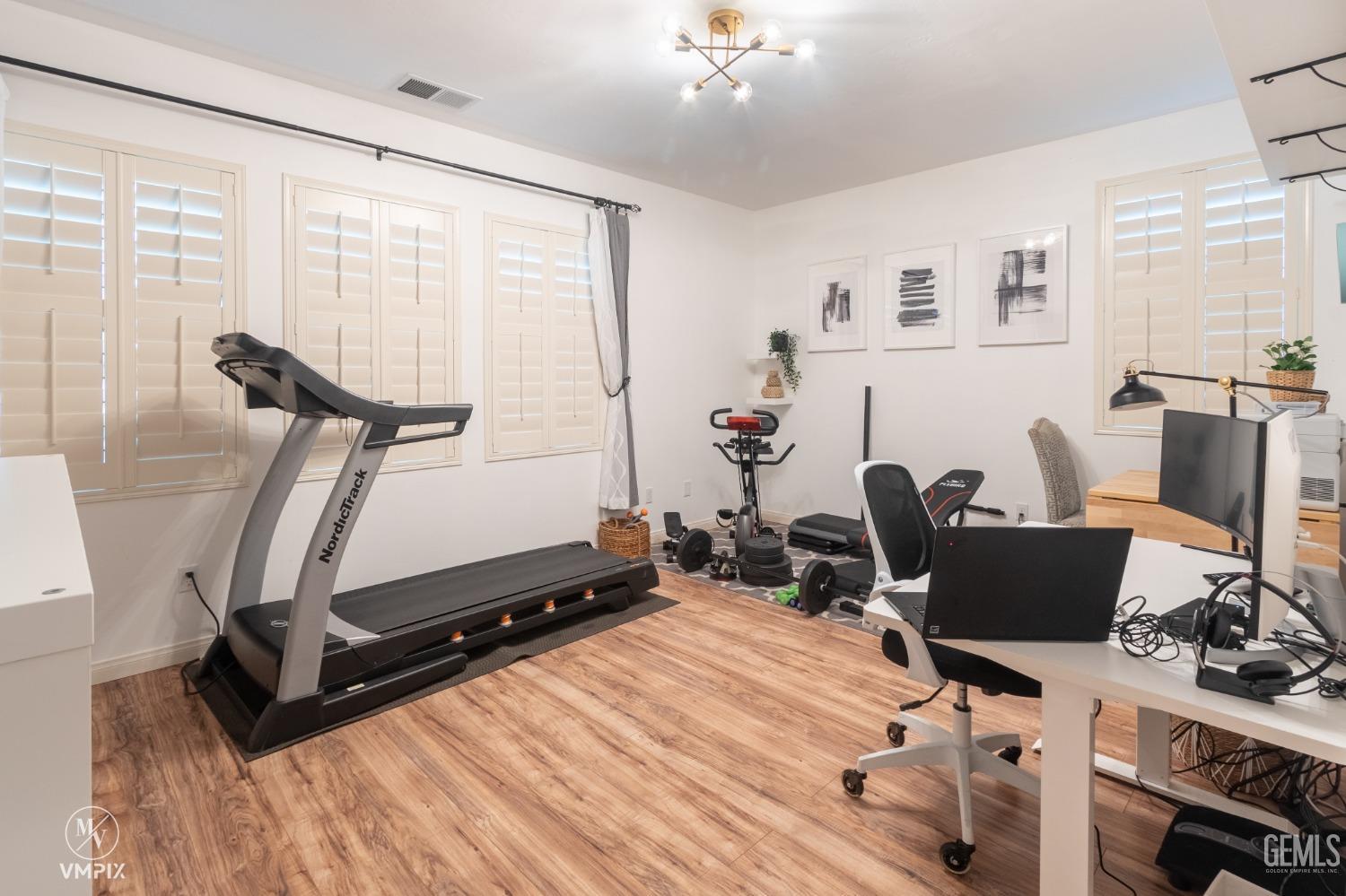 Undisclosed Address Bakersfield, CA 93311 - Photo 23 of 55 a room with gym equipment and windows