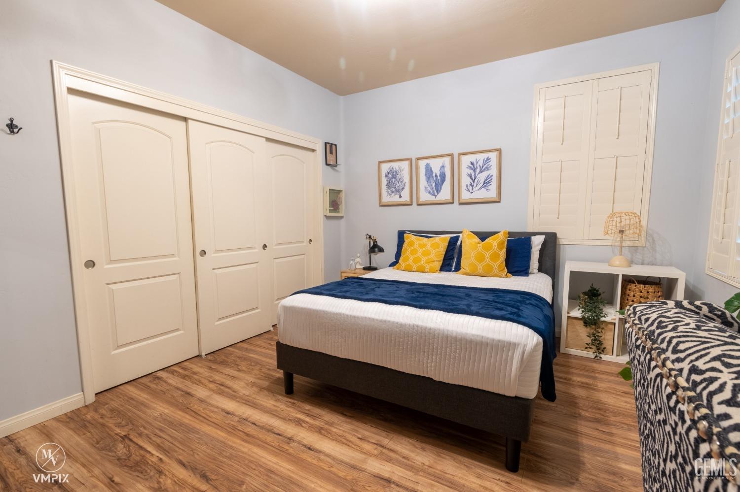 Undisclosed Address Bakersfield, CA 93311 - Photo 26 of 55 a bedroom with a bed and wooden floor