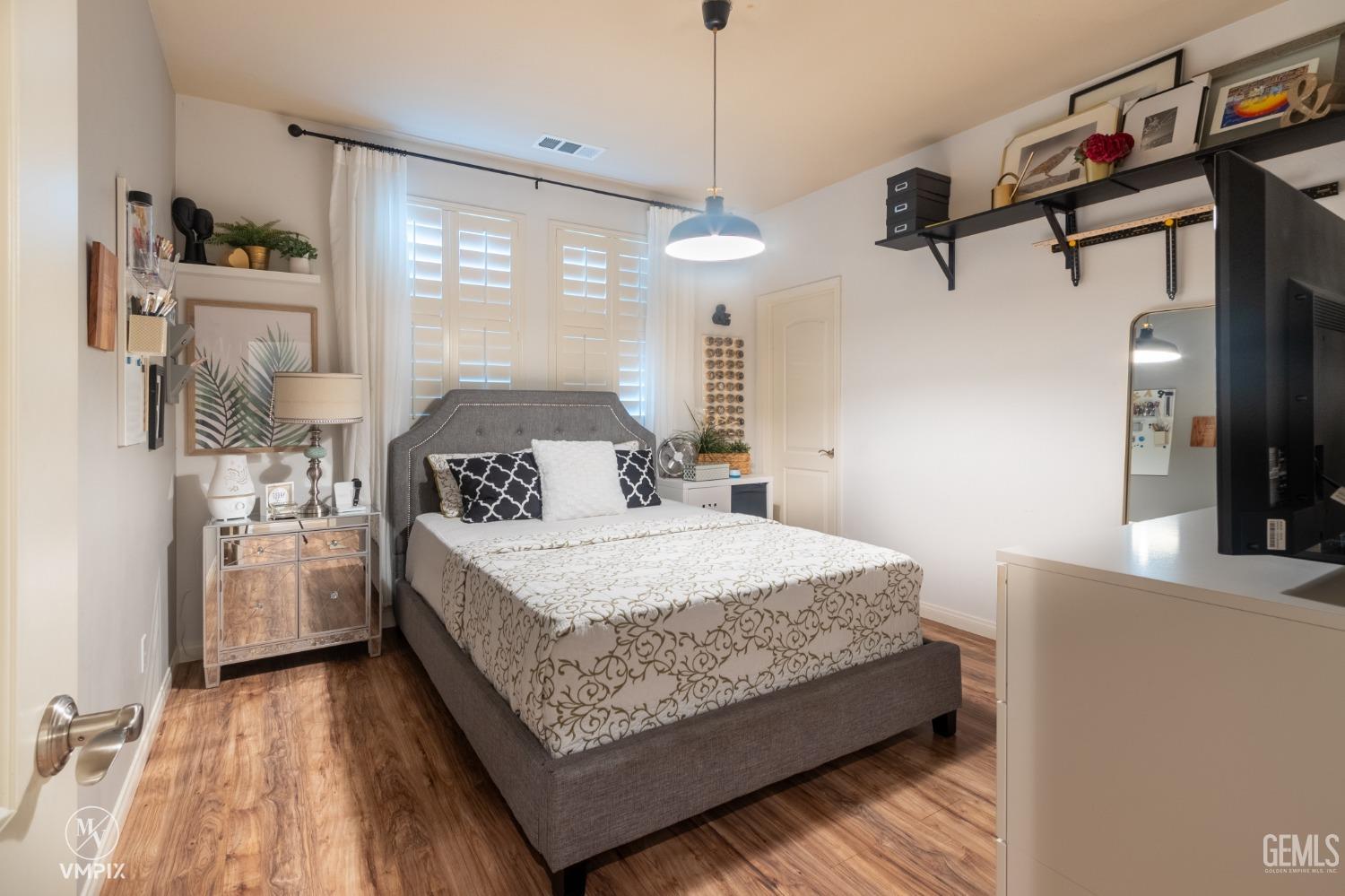 Undisclosed Address Bakersfield, CA 93311 - Photo 30 of 55 a bedroom with a bed and a chandelier