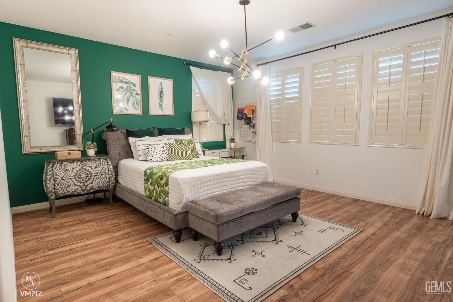 Undisclosed Address Bakersfield, CA 93311 - Photo 31 of 55 a bedroom with a bed chandelier and a window