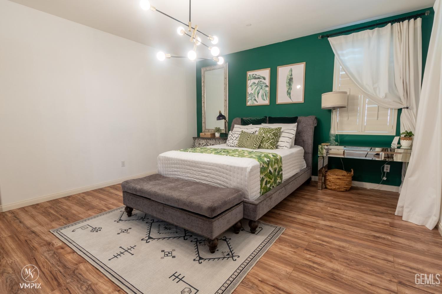 Undisclosed Address Bakersfield, CA 93311 - Photo 32 of 55 a spacious bedroom with a bed and a table