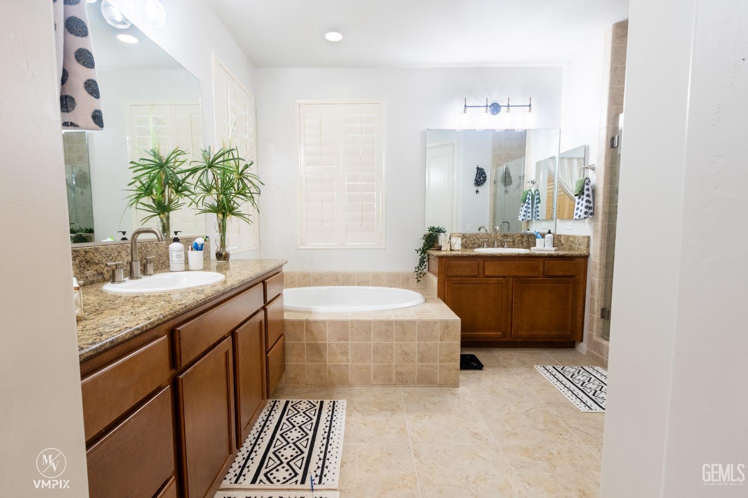 Undisclosed Address Bakersfield, CA 93311 - Photo 33 of 55 a spacious bathroom with a tub sink and mirror