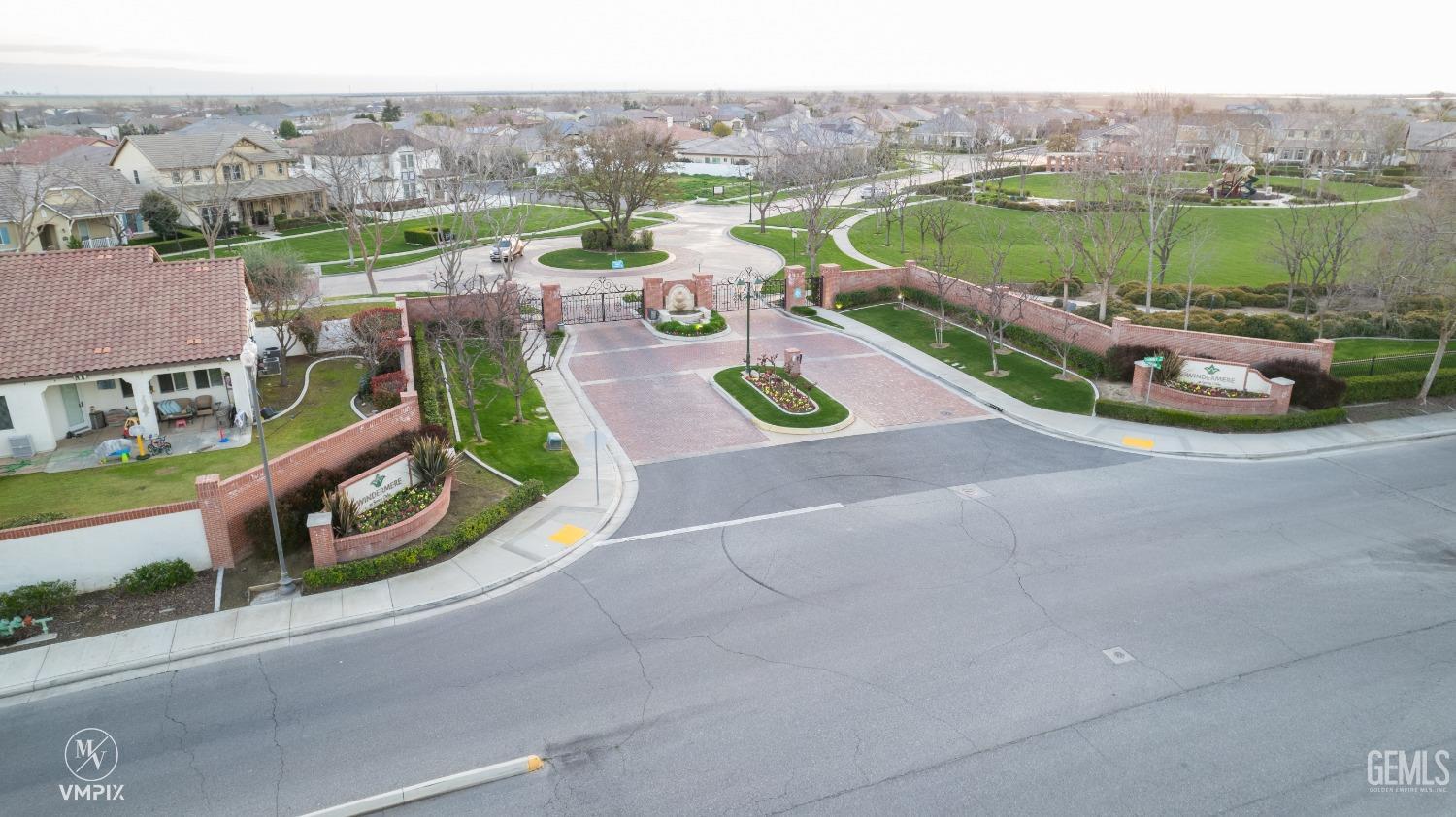 Undisclosed Address Bakersfield, CA 93311 - Photo 4 of 55 an aerial view of a house with a garden and lake view