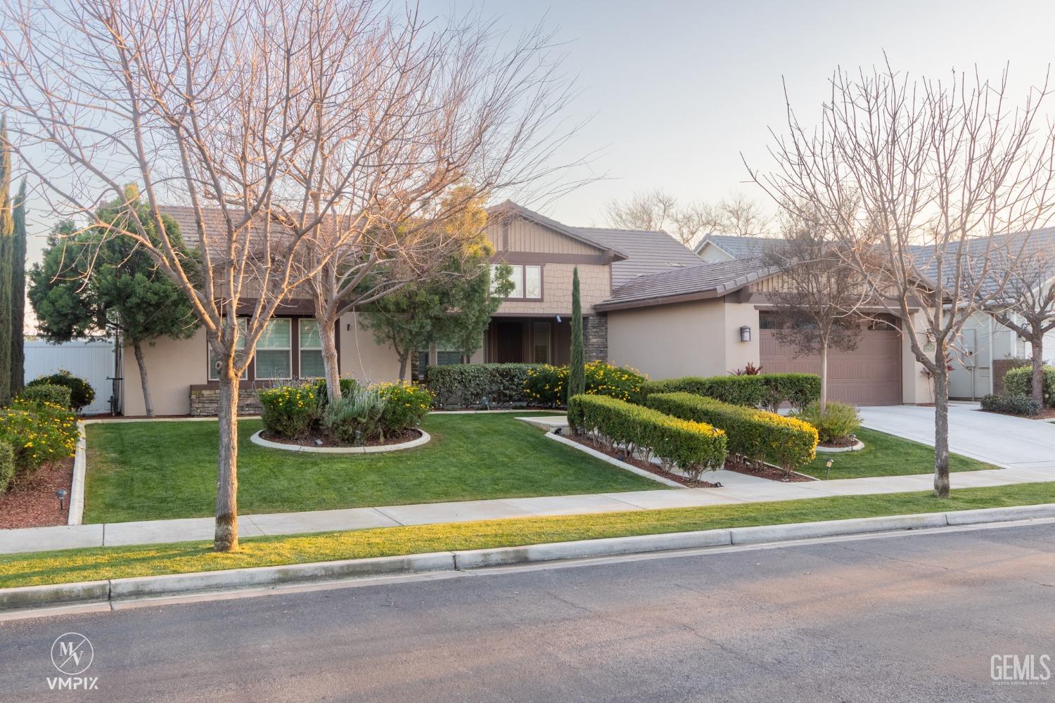 Undisclosed Address Bakersfield, CA 93311 - Photo 7 of 55 a view of a house with a yard and large tree