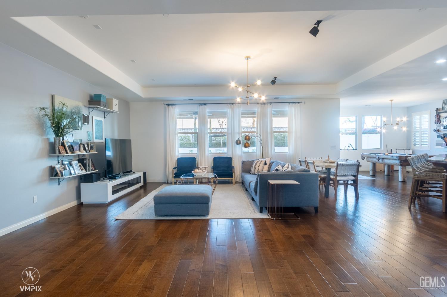 Undisclosed Address Bakersfield, CA 93311 - Photo 10 of 55 a living room with furniture and a chandelier