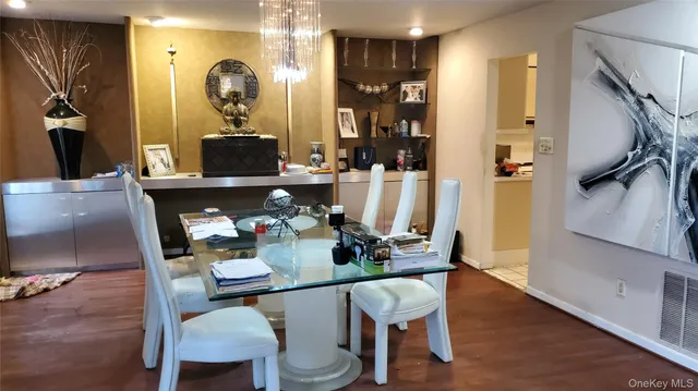 a dining room with furniture and wooden floor