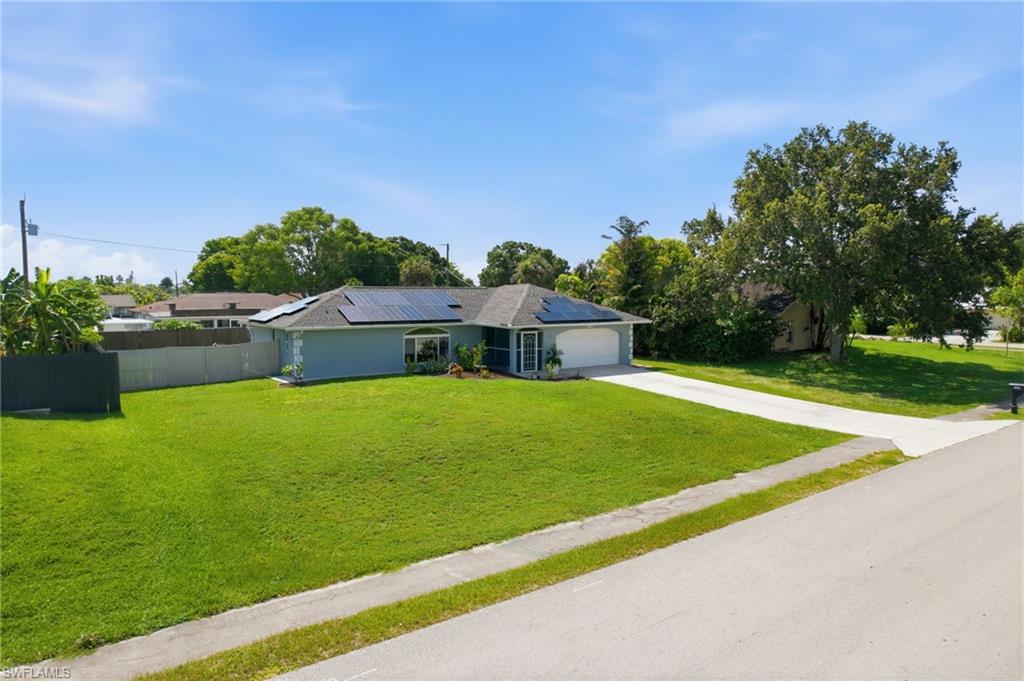 3022 47th Street Southwest Naples, FL 34116 - Photo 42 of 46 Light blue single-story residence with an attached two-car garage