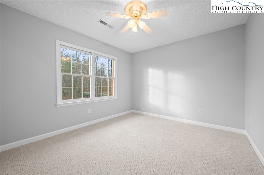 458 Jim Caudill Road Wilkesboro, NC 28697 - Photo 24 of 50 an empty room with a window and a fan
