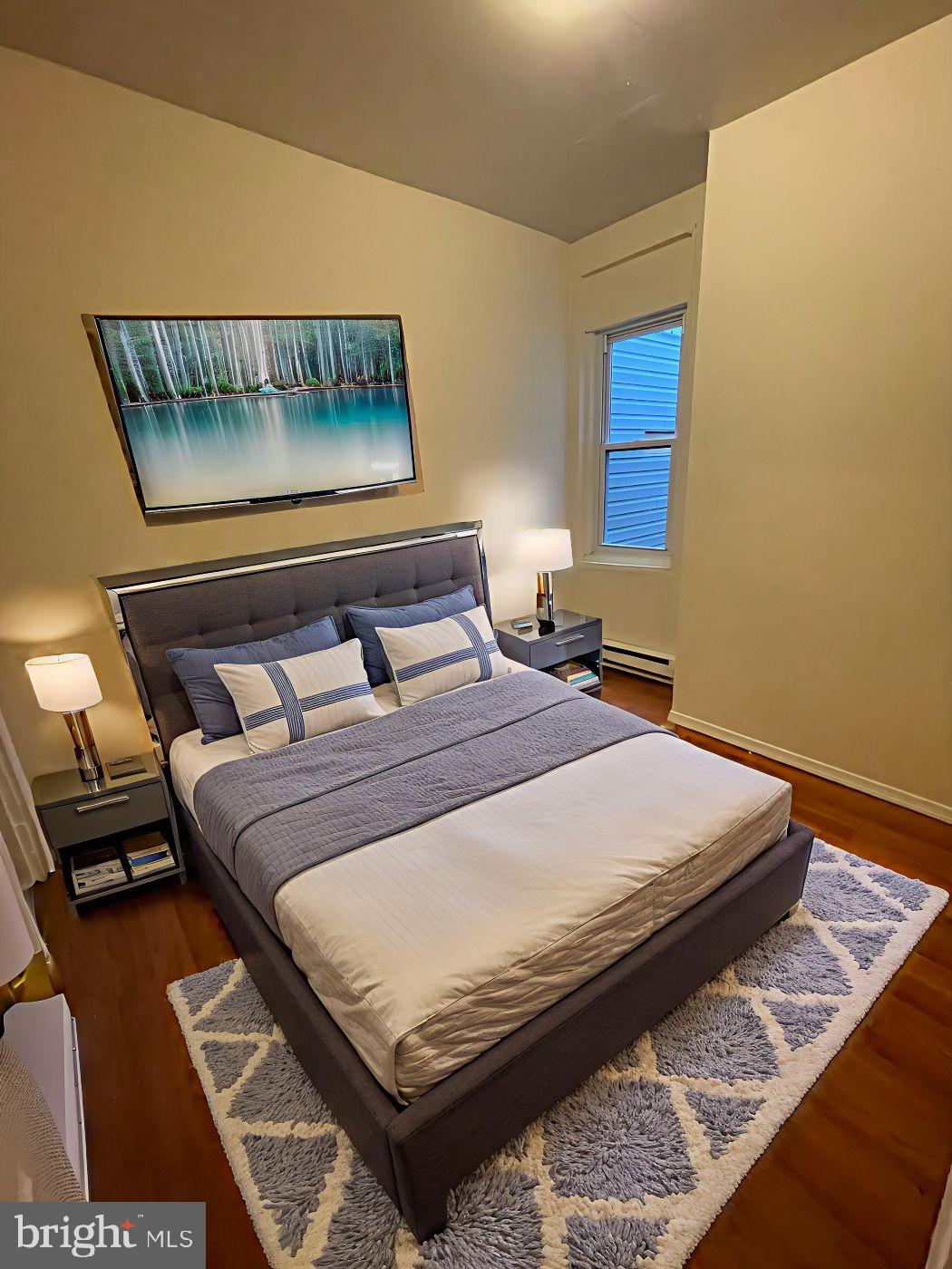 3432 Ormes Street Philadelphia, PA 19134 - Photo 3 of 10 a bed sitting in a bedroom next to a window