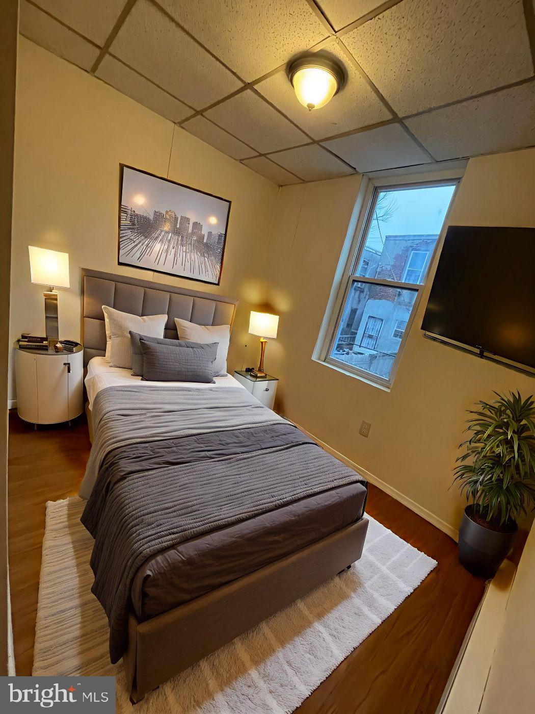 3432 Ormes Street Philadelphia, PA 19134 - Photo 4 of 10 a bedroom with a bed and a potted plant